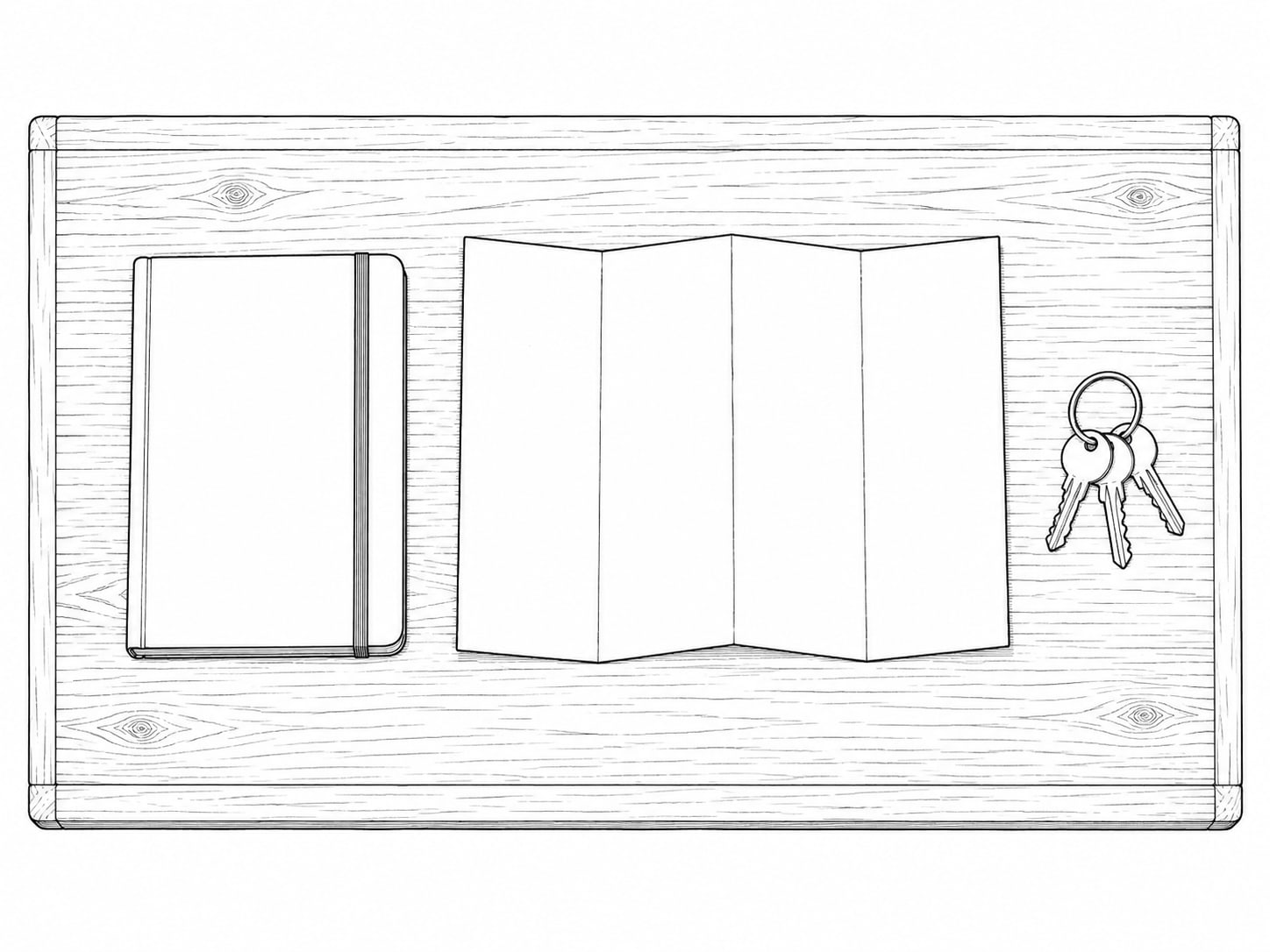 Un llavero y un mapa de papel doblado sobre una mesa de madera junto a un cuaderno cerrado.