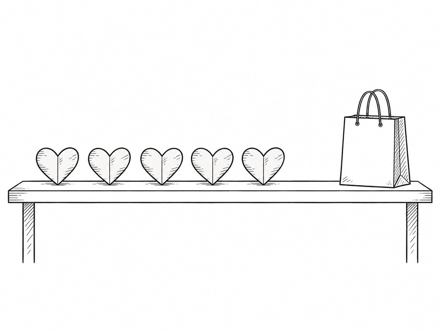 A row of small paper hearts on a table, with one plain shopping bag standing apart at the end.