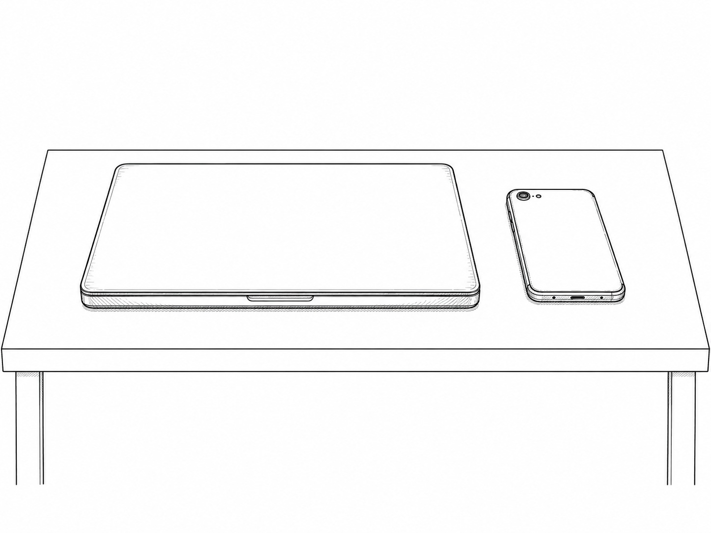 A closed laptop and a phone lying face down side by side on a clean oak desk in soft morning light.