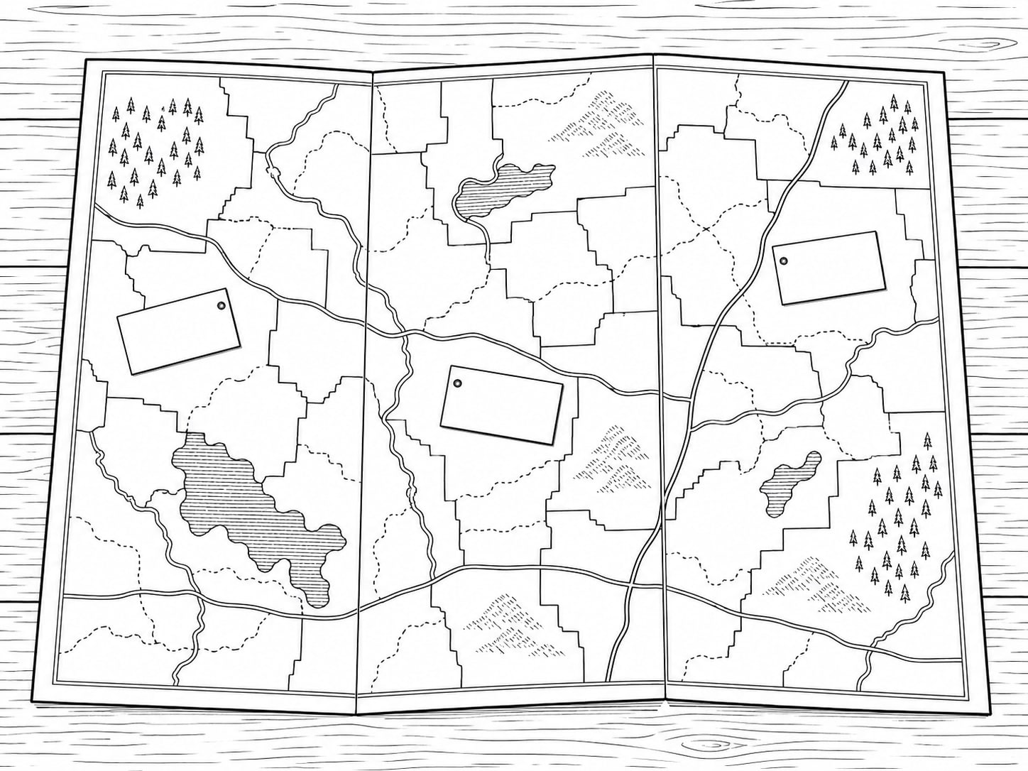 A county map folded into thirds on a table, with three small unmarked paper tags resting on it.