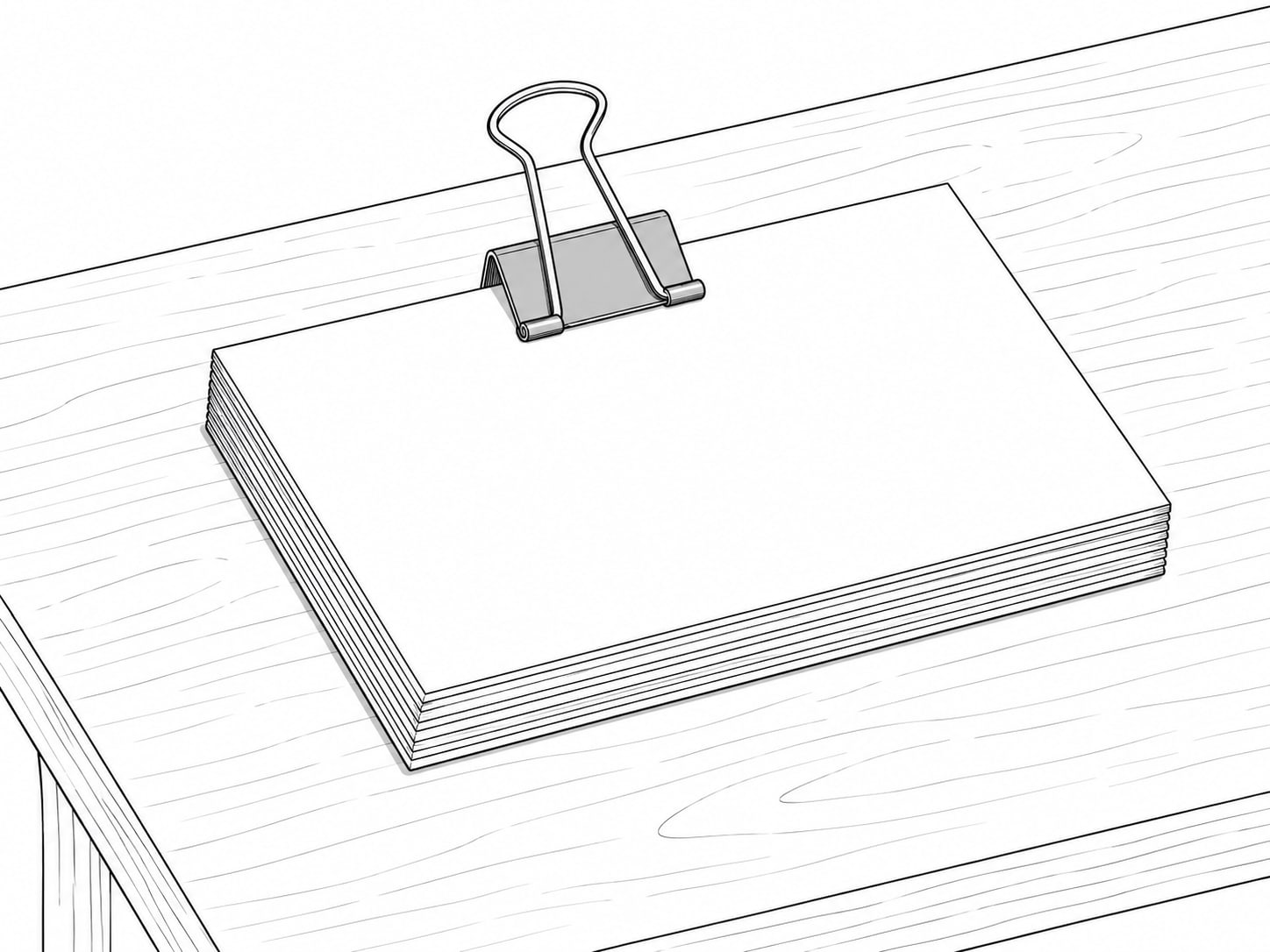 A small stack of index cards held together with a metal clip on a table.