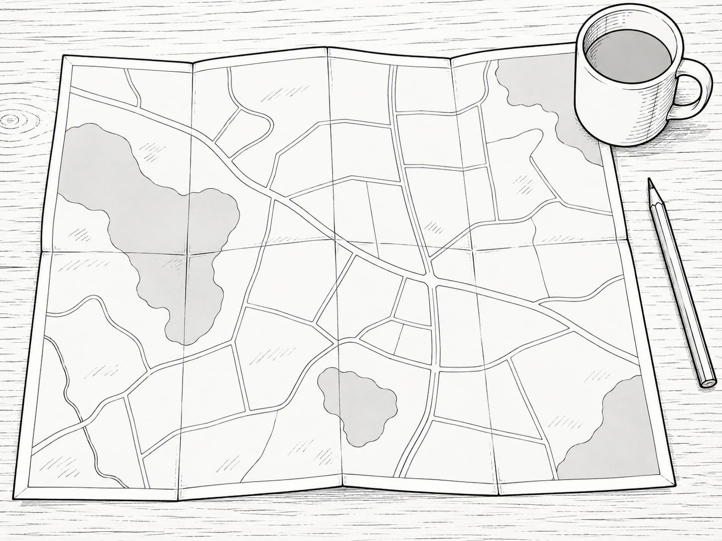 A paper road map folded open on a table with a small ceramic mug set on one corner and a blunt pencil beside it.