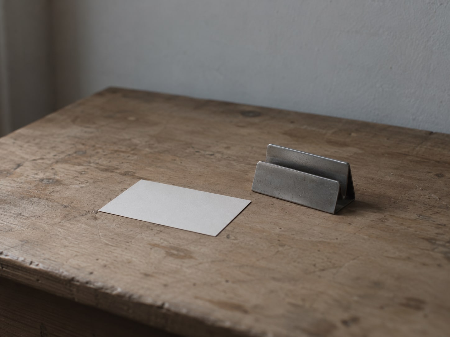 A printed review request card face down beside a small stand on a front desk.