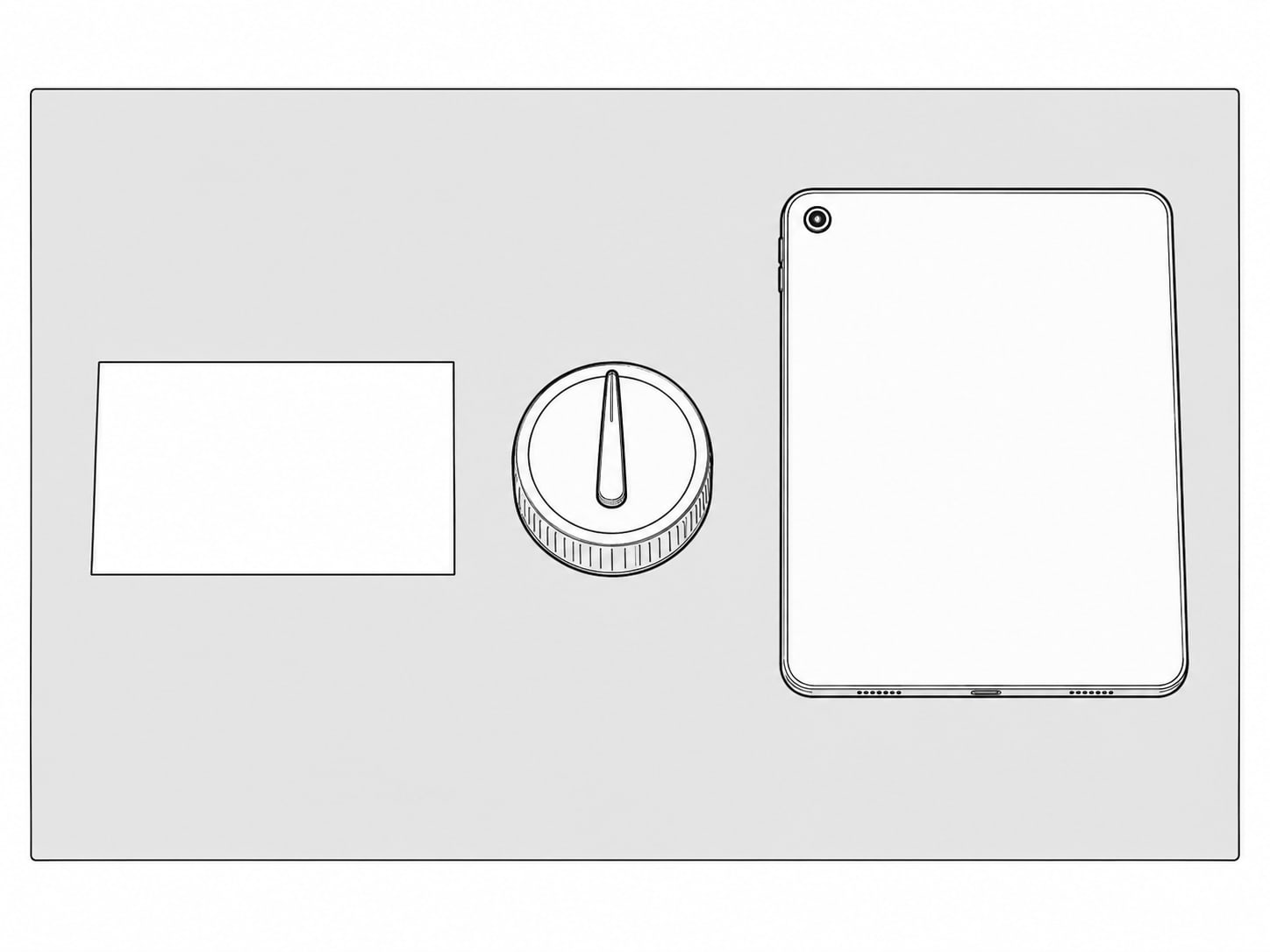 A small kitchen timer next to a blank index card and a closed tablet on a pale gray table.
