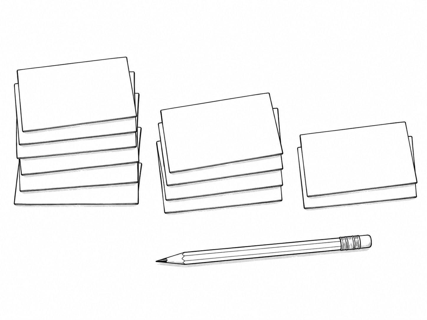 A stack of blank index cards sorted into three loose piles on a clean workbench, with a pencil beside them.