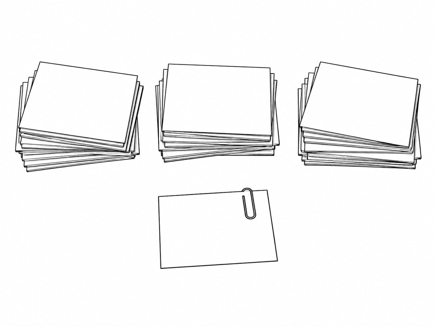 Index cards sorted into three loose piles on a table, one card set apart with a paperclip.
