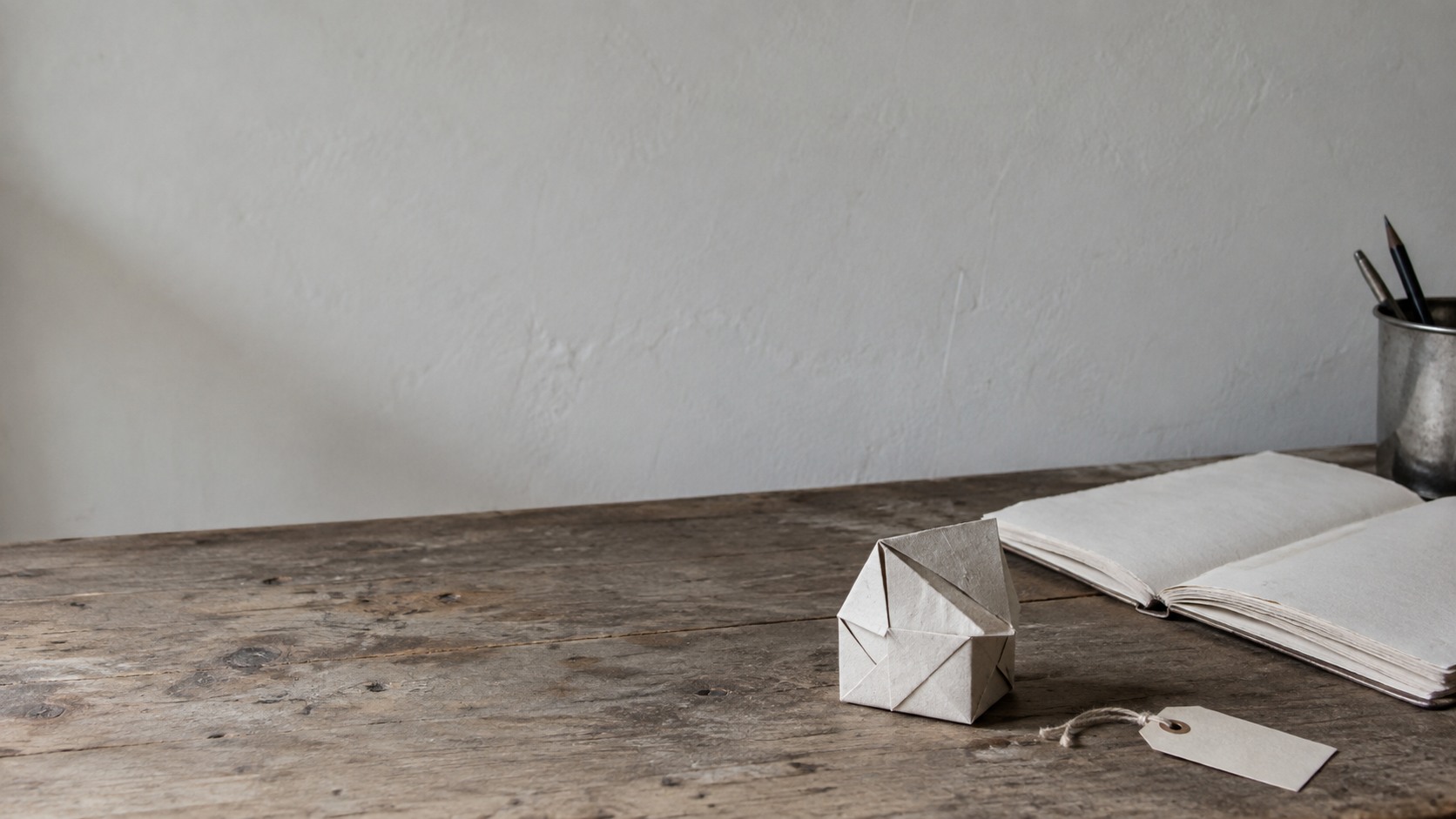 A small paper model of a product sitting on a desk beside a price tag and an empty order book, before anything is built.